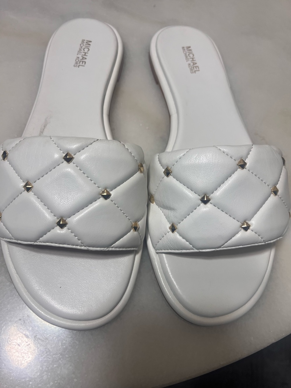 Michael Kor’s White Gold Slip on Sandals